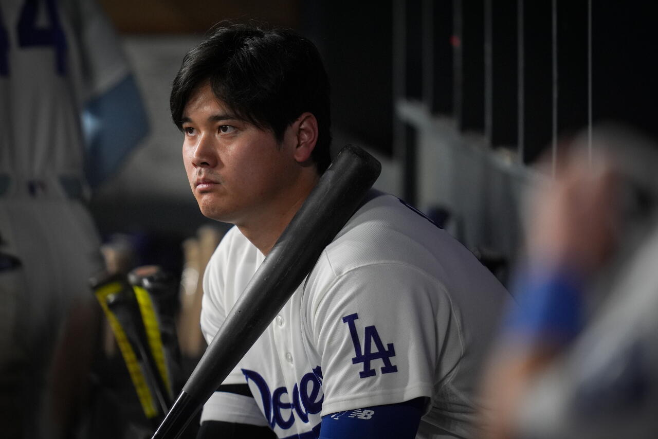 Los Angeles Dodgers designated hitter Shohei Ohtani watches from the dugout during the ninth inning.