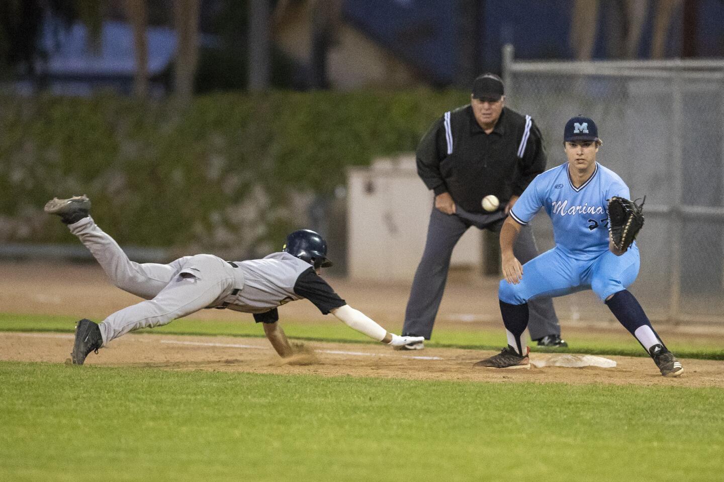 Marina's Cory Lewis, representing the North, takes the throw to keep Capistrano Valley's Lance Gardiner at first base during the Kiwanis Club of Greater Anaheim's 52nd Orange County High School All-Star Baseball Game for seniors at La Palma Park's Dee Fee Field in Anaheim on Tuesday.