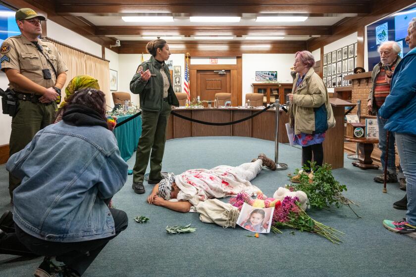 OJAI, CA - Feb. 13, 2024: Ventura County SheriffOs talk to activists who interrupted an Ojai city council meeting, with Cyrus Mayer doing a die-in, urging the city council to pass a resolution for a ceasefire in the IsraeliDPalestinian conflict. (Michael Owen Baker / For The Times)