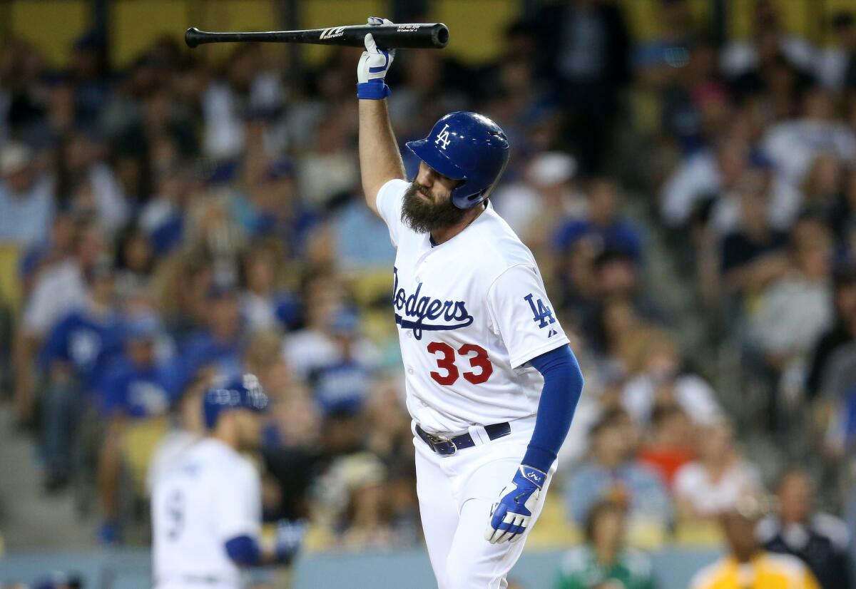 Scott Van Slyke reacts after flying out to end an inning with a runner on third base during the Dodgers' 9-5 loss to the San Francisco Giants at Dodger Stadium.