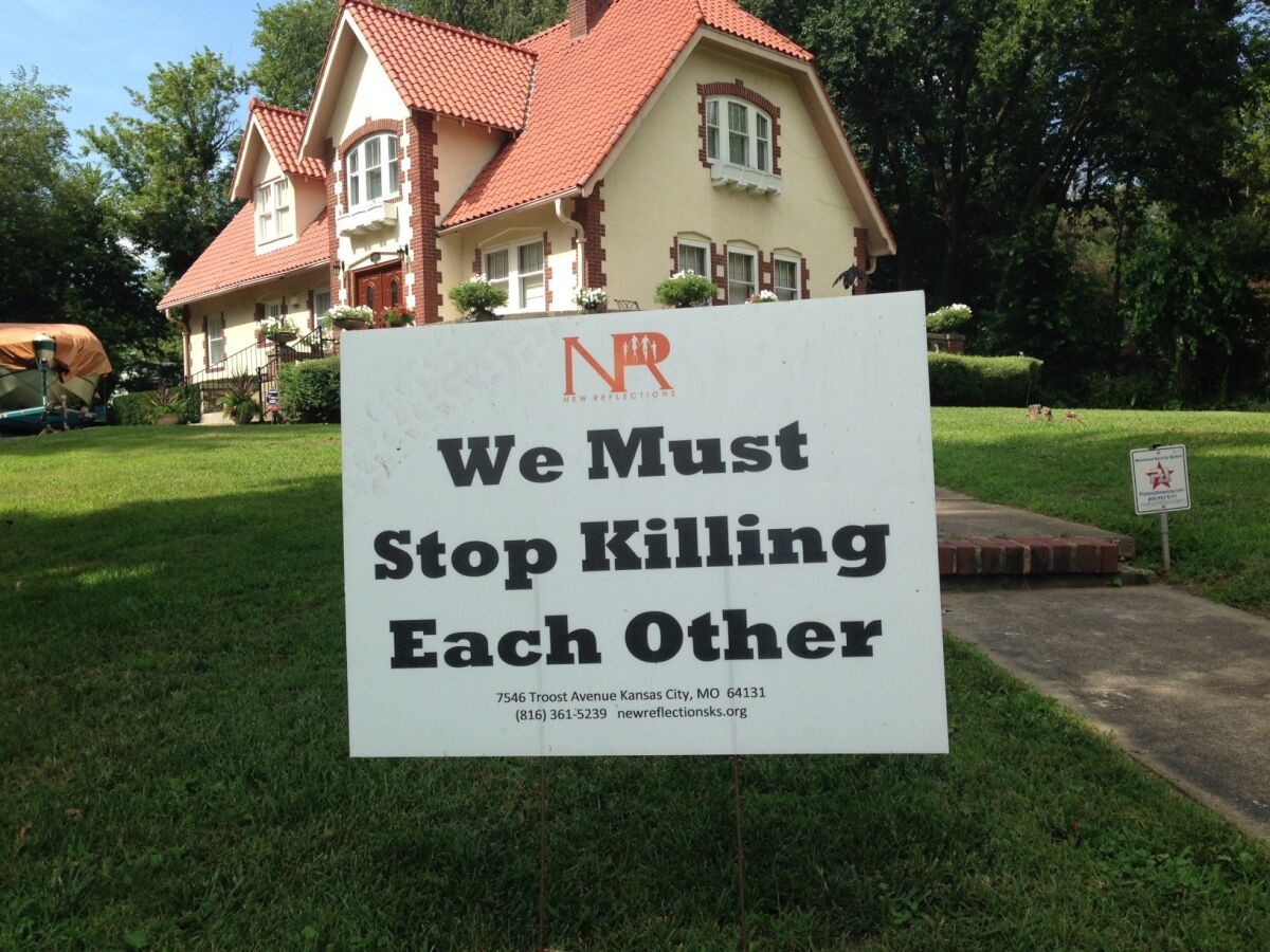 This anti-violence sign is found on many lawns in the Kansas City, Mo., neighborhood where gunman Gavin Long lived.