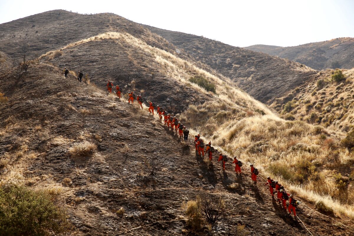 Firefighters prepare to battle the Soledad fire near Agua Dulce on Monday morning.