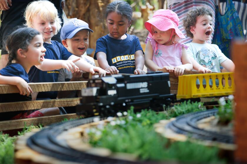 LA CANADA-CA-JULY 11, 2024: Children watch miniature trains at The Descanso Railroad, now open at Descanso Gardens in La Canada Flintridge on July 11, 2024. (Christina House / Los Angeles Times)