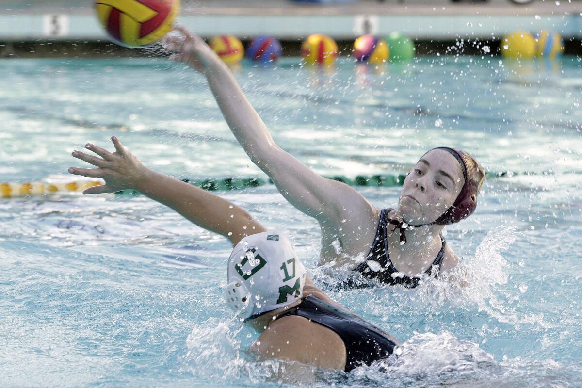 La Canada's Shelby Hovanesian shoots with Monrovia's Charlotte Gray approaching in a Rio Condo League girls' water polo game at La Canada High School on Thursday, January 23, 2020.