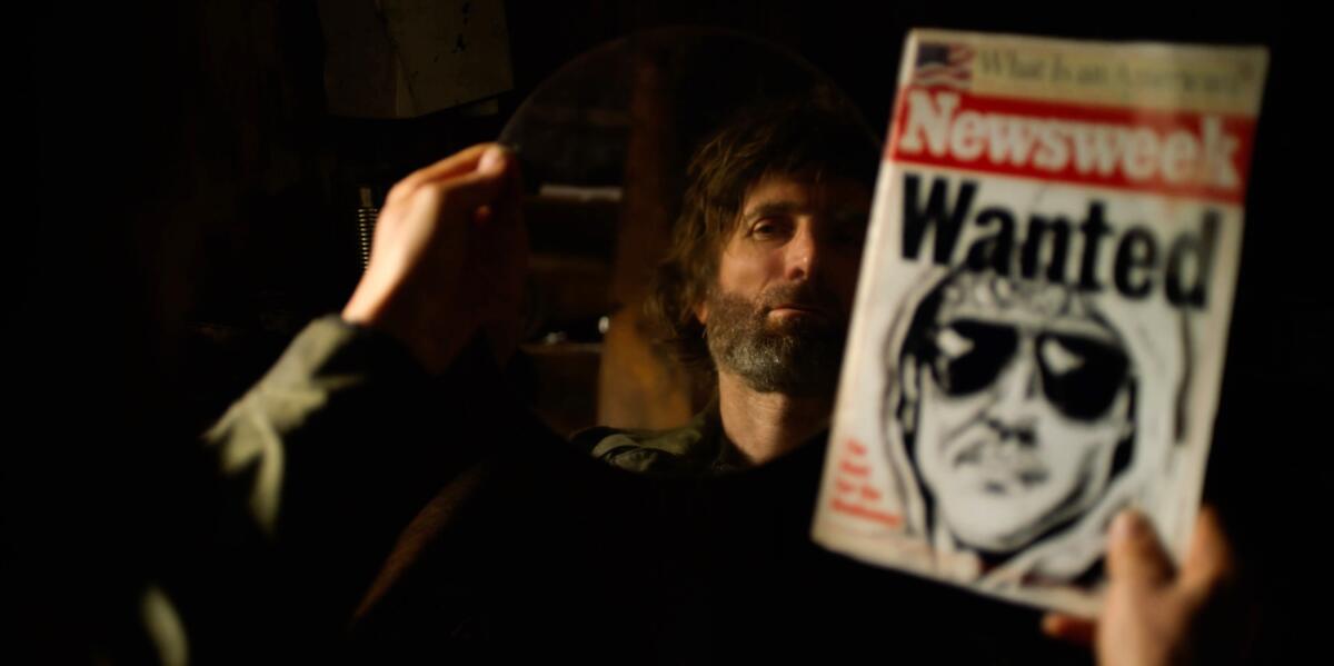 A man looks in the mirror while holding up a Newsweek magazine with a witness sketch on the cover.