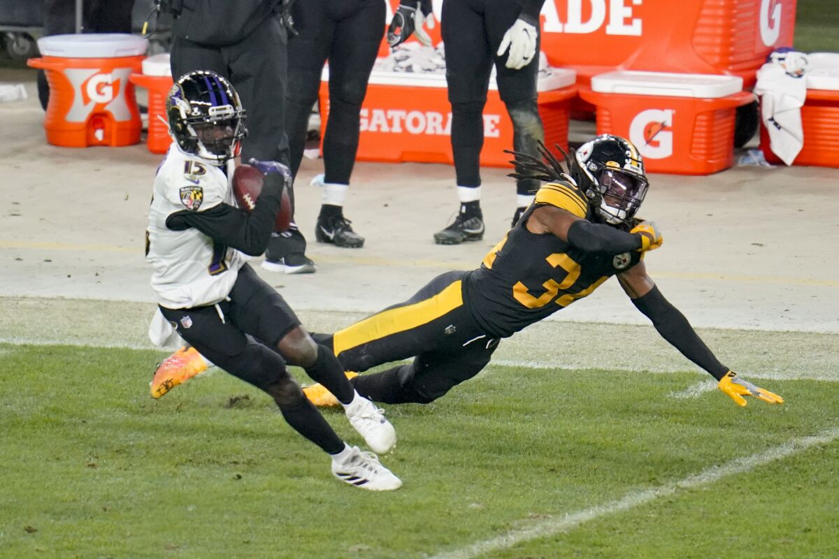 Baltimore Ravens wide receiver Marquise Brown (15) makes a catch in front of Pittsburgh Steelers strong safety Terrell Edmunds (34) and gets away to score a touchdown in the second half during an NFL football game, Wednesday, Dec. 2, 2020, in Pittsburgh. The Steelers won 19-14. (AP Photo/Gene J. Puskar)