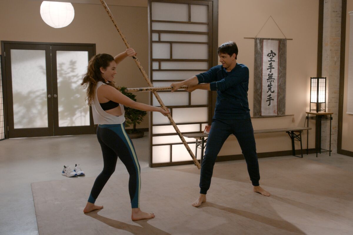 Mary Mouser  and Ralph Macchio in a scene from "Cobra Kai."