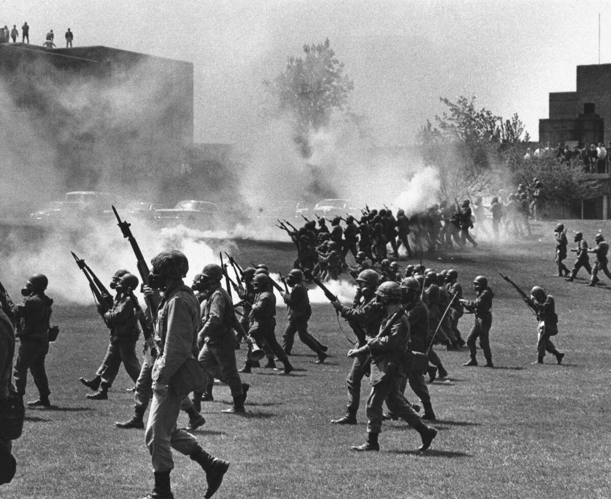 Ohio National Guard troops move in on protesting students at Kent State University on May 4, 1970.