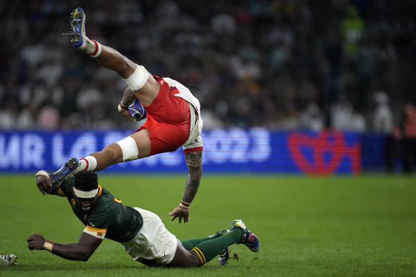 South Africa's captain Siya Kolisi, bottom, tackles Tonga's captain Halaleva Fifita during the Rugby World Cup Pool B match between South Africa and Tonga at the Stade de Marseille, in Marseille, France Sunday, Oct. 1, 2023. (AP Photo/Daniel Cole)