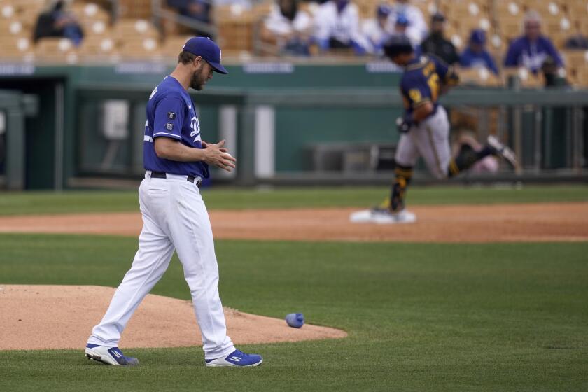 Dodgers pitcher Clayton Kershaw rubs up a new baseball.