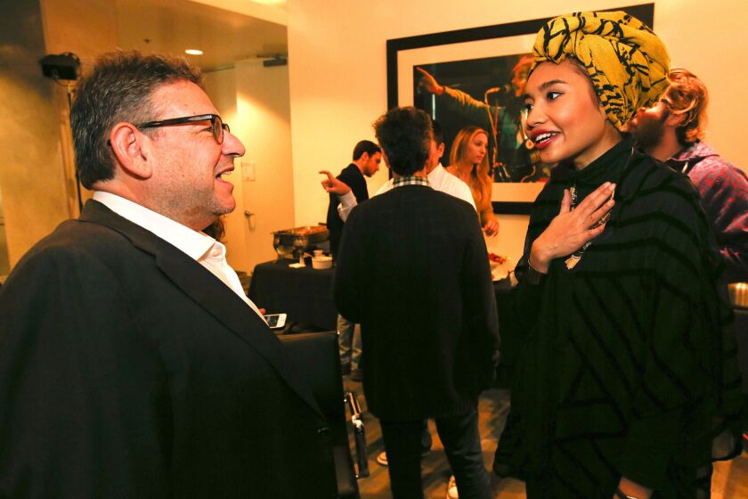 Lucian Grainge, chairman of Universal Music Group, greets Yuna, a 27-year-old pop singer from Malaysia, after she performed for a group of executives at the record company's Santa Monica headquarters in November.