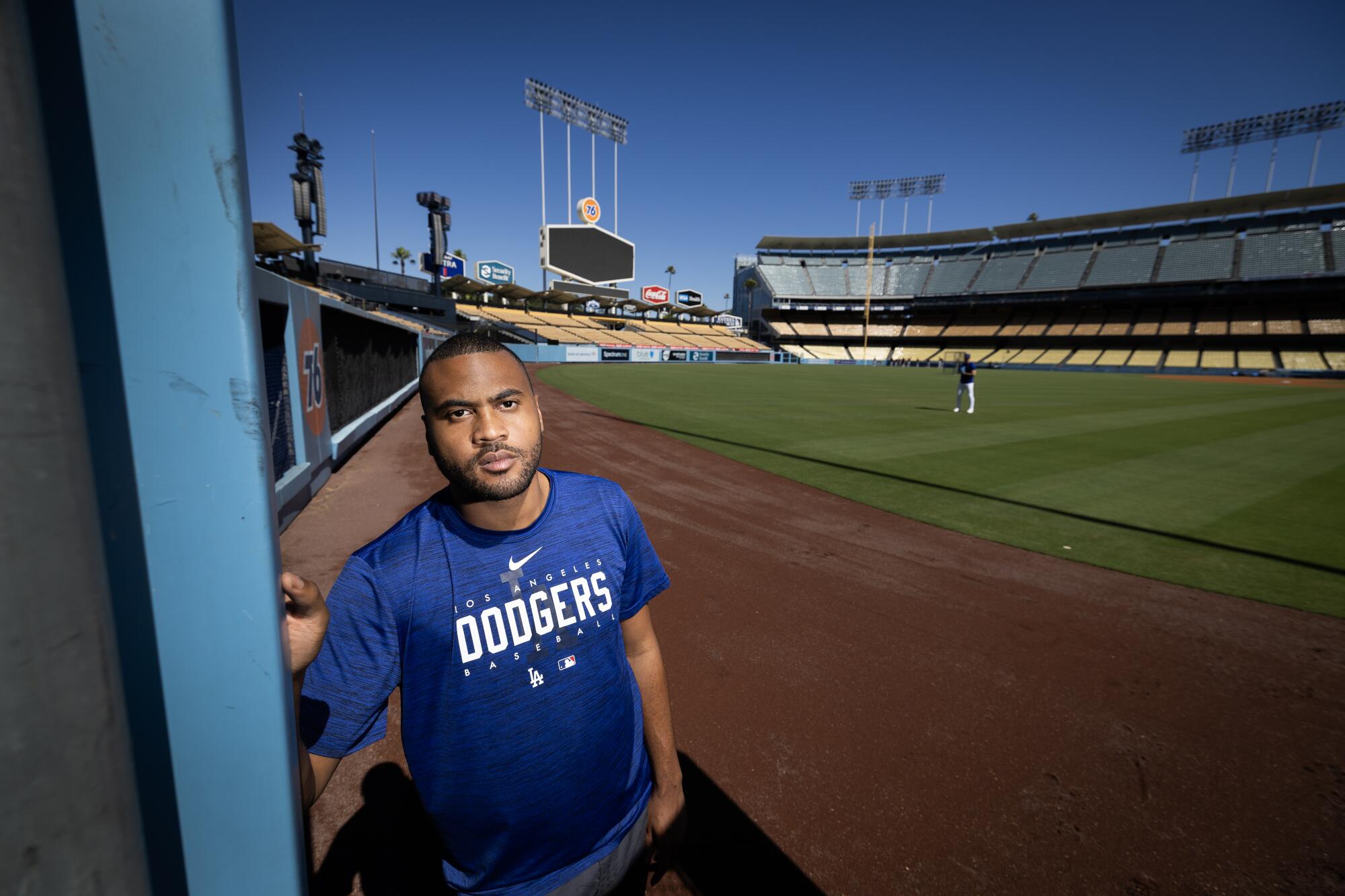 RJ Peete, a Dodgers clubhouse attendant, prepares the bullpen before every game at Dodger Stadium.