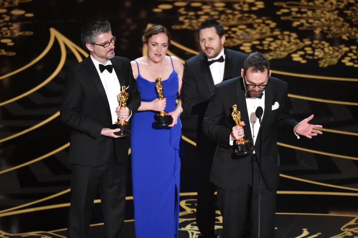 From left, Mark Williams Ardington, Sara Bennett, Paul Norris, and Andrew Whitehurst accept the visual effects Oscar for "Ex Machina."