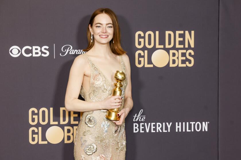 BEVERLY HILLS, CALIFORNIA - JANUARY 7: 81st GOLDEN GLOBE AWARDS -- US actress Emma Stone poses with the award for Best Performance by a Female Actor in a Motion Picture - Musical or Comedy for "Poor Things" in the press room during the 81st Annual Golden Globe Awards held at the Beverly Hilton Hotel on January 7, 2024. (Photo by Jason Armond / Los Angeles Times)