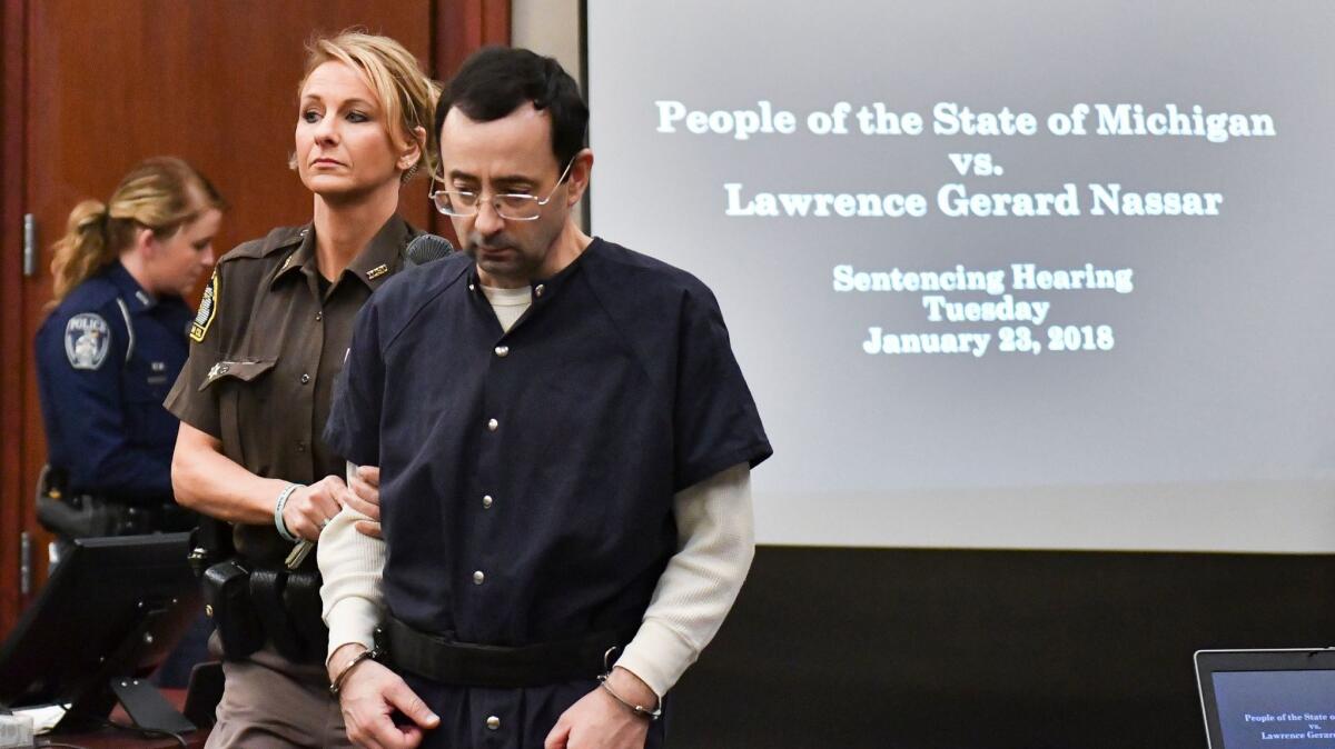 Larry Nassar is brought into court on Tuesday in Lansing, Mich. Nassar has admitted sexually assaulting athletes under the guise of medical treatment when he was employed by Michigan State University and USA Gymnastics.