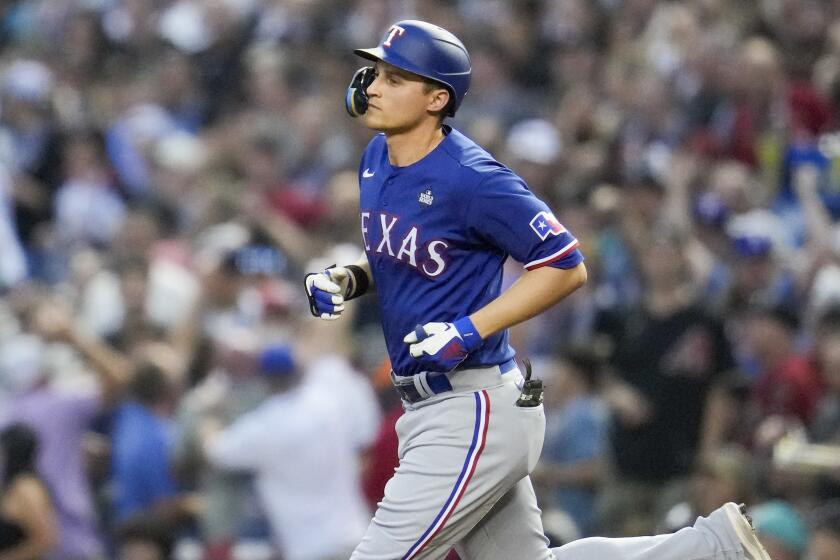 Texas Rangers' Corey Seager rounds the bases after a two-run home run.