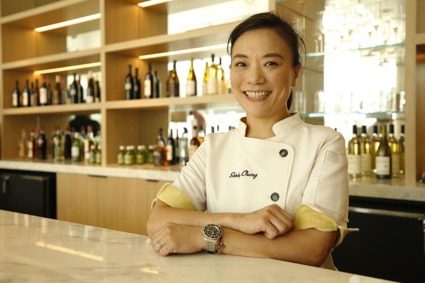 Chef Shirley Chung poses in chef's whites in the kitchen at Abernethy's Restaurant at the L.A. Music Center in 2019
