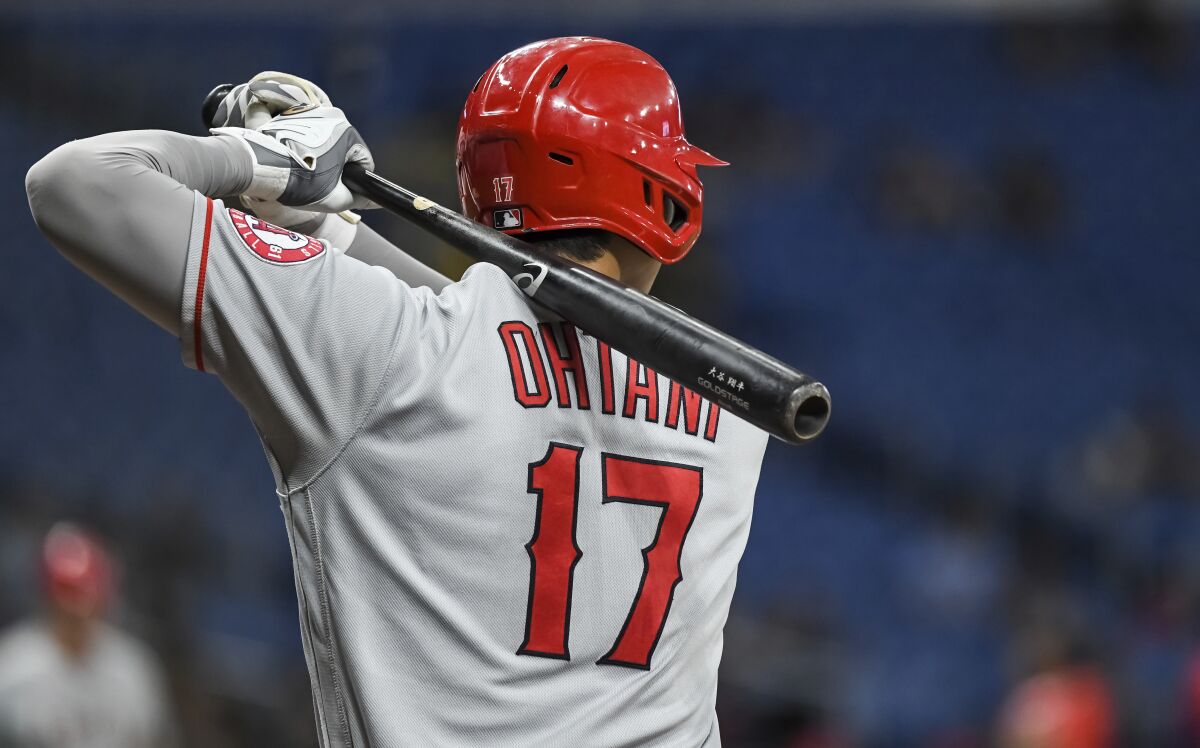 A view of Shohei Ohtani from behind, with the bat resting on his shoulder