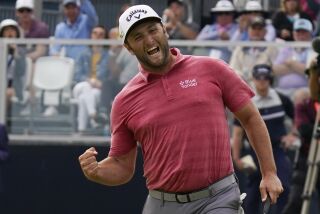 Jon Rahm, of Spain, reacts to making his birdie putt on the 18th green during the final round.