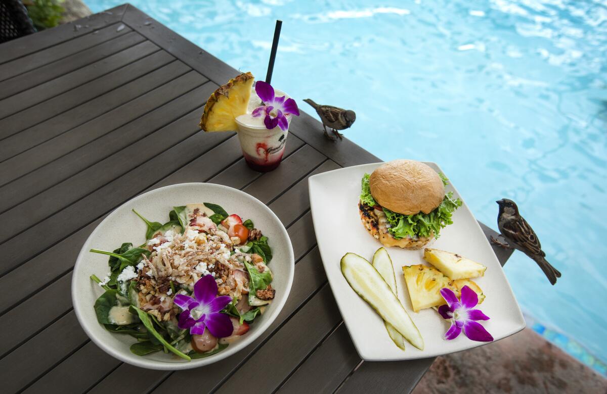 Kula spinach salad, left, $16, and a turkey burger, $19, are on the menu at the Volcano Bar in the Grand Wailea Resort Hotel in Wailea, Hawaii.