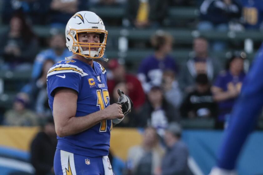 Chargers quarterback Philip Rivers walks off the field after having a pass intercepted for the third time during a game against the Vikings at Dignity Health Sports Park.