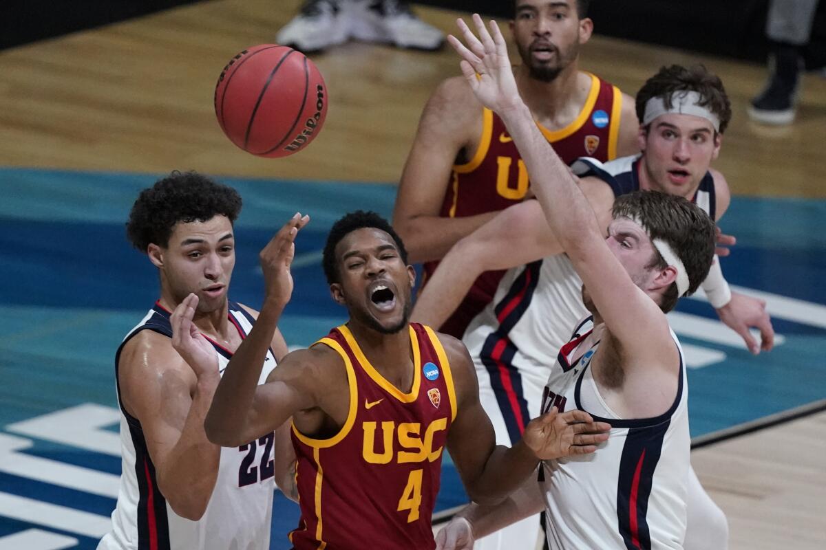 USC forward Evan Mobley loses the ball between Gonzaga's Anton Watson and forward Drew Timme.