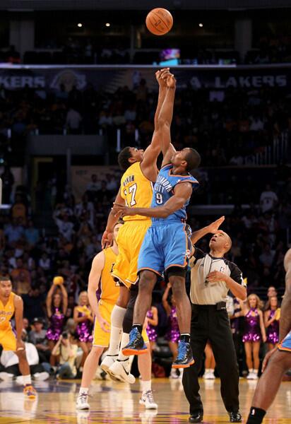 Andrew Bynum and Serge Ibaka leap for the opening jump ball to start Game 4.