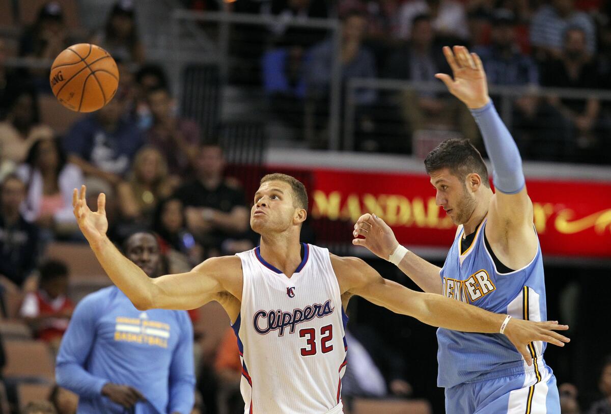 Clippers forward Blake Griffin reaches for the ball in front of Denver center Jusuf Nurkic on Saturday night.