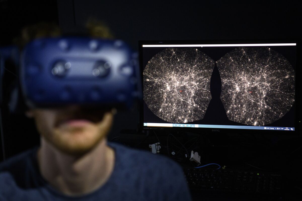 Hadrien Gurnel, a software engineer with EPFL's Laboratory for Experimental Museology, uses a virtual reality helmet.