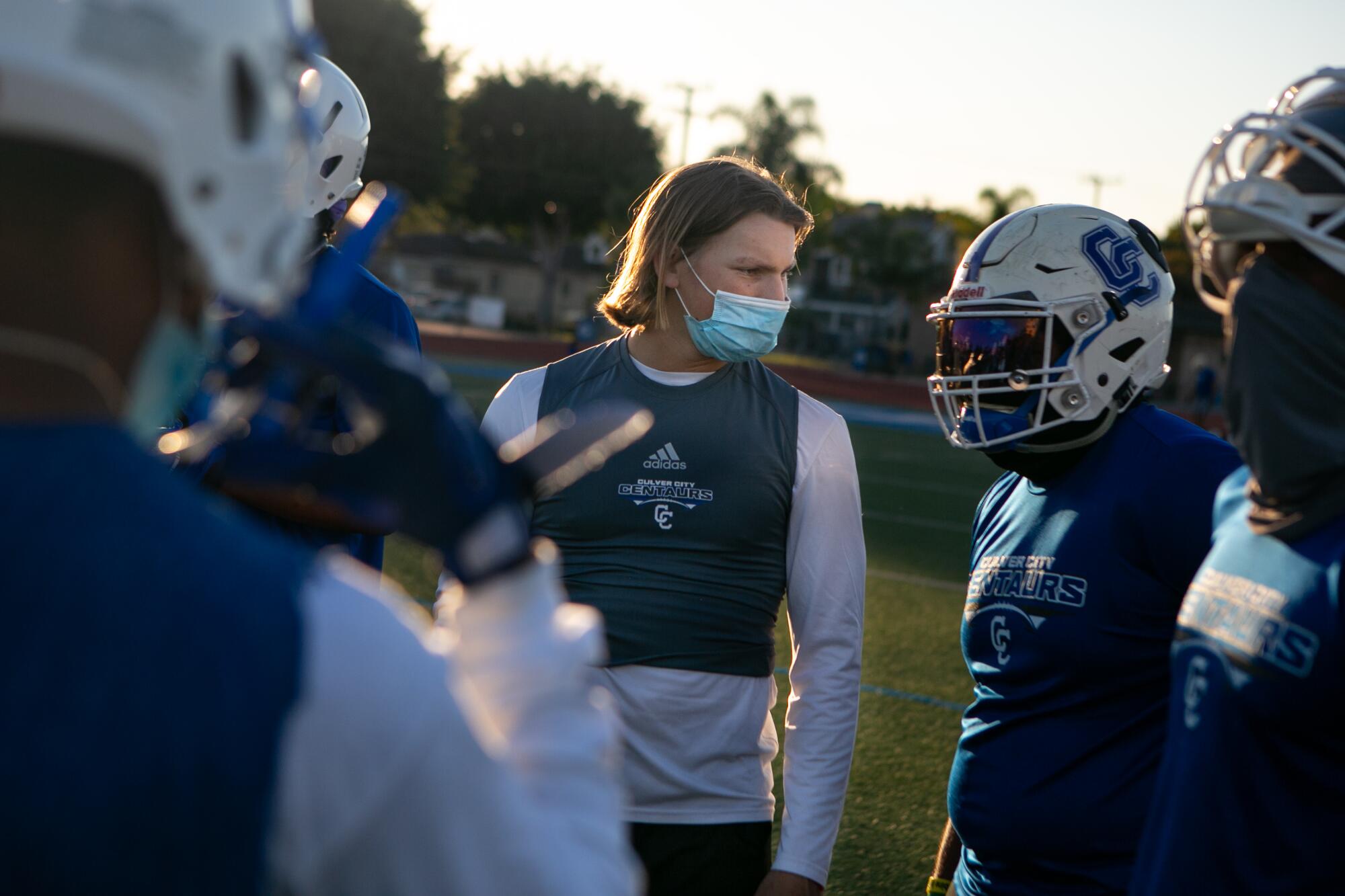 Culver City quarterback Zevi Eckhaus and other players are masked up during the first official football practice.