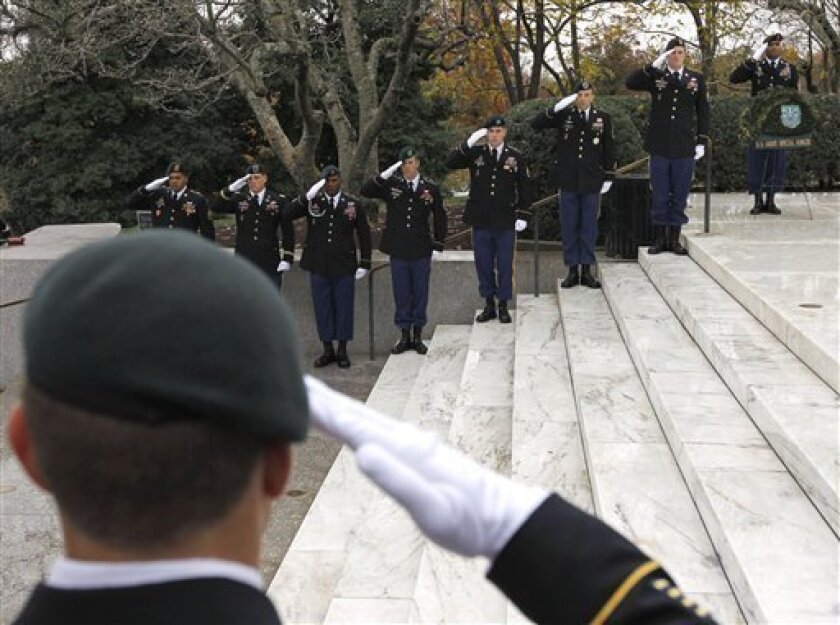 Members of the U.S. Army Special Forces Green Berets salute during a ceremony commemorating the 50th anniversary of President John F. Kennedy's designation of the name of the Special Forces Green Berets, Thursday, Nov. 17, 2011, at Arlington National Cemetery in Arlington, Va. (AP Photo/Ann Heisenfelt)