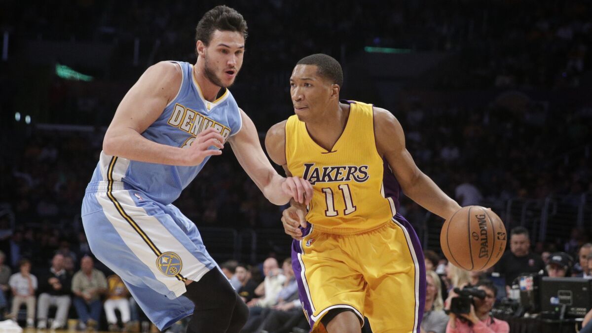 Lakers forward Wesley Johnson, right, tries to drive past Denver Nuggets forward Danilo Gallinari during a game on Feb. 10.