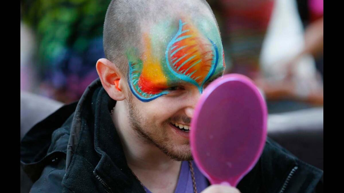 Dmitriy Klyagin, 25, of San Diego, checks out the paint job at the Desert Hearts music festival.