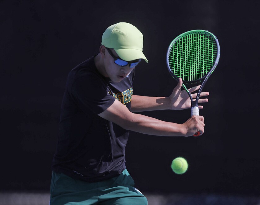 Edison's Dylan Trinh hits a backhand in his match against Laguna Beach on Monday.