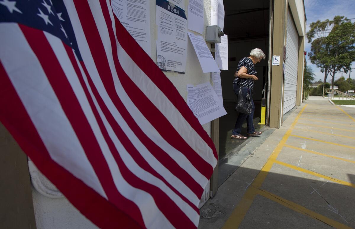 A voter emerges from the Royal Palm Fire Station polling place in Costa Mesa after voting in March 2015. Costa Mesa voters will decide the fates of eight ballot measures this year, the most ever for the city in one election.