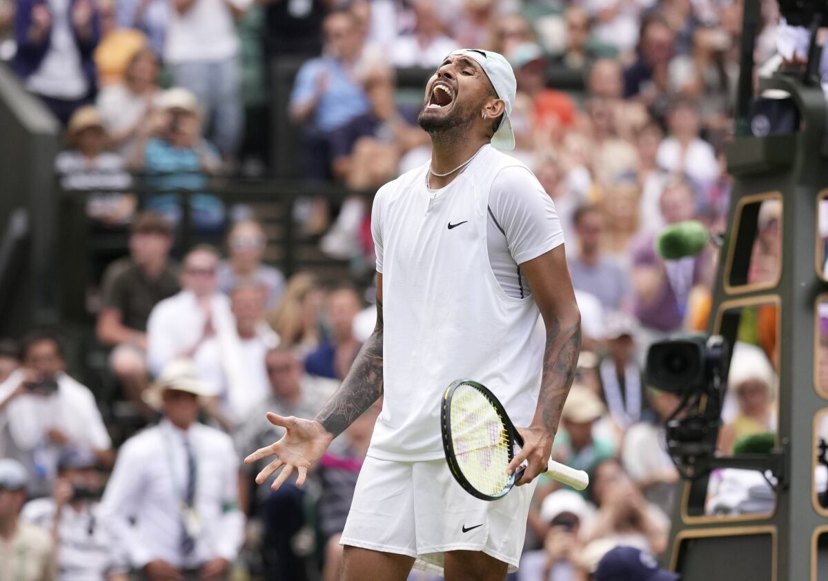 Australia's Nick Kyrgios celebrates after beating Brandon Nakashima of the US in a men's singles fourth round match on day eight of the Wimbledon tennis championships in London, Monday, July 4, 2022. (AP Photo/Alberto Pezzali)