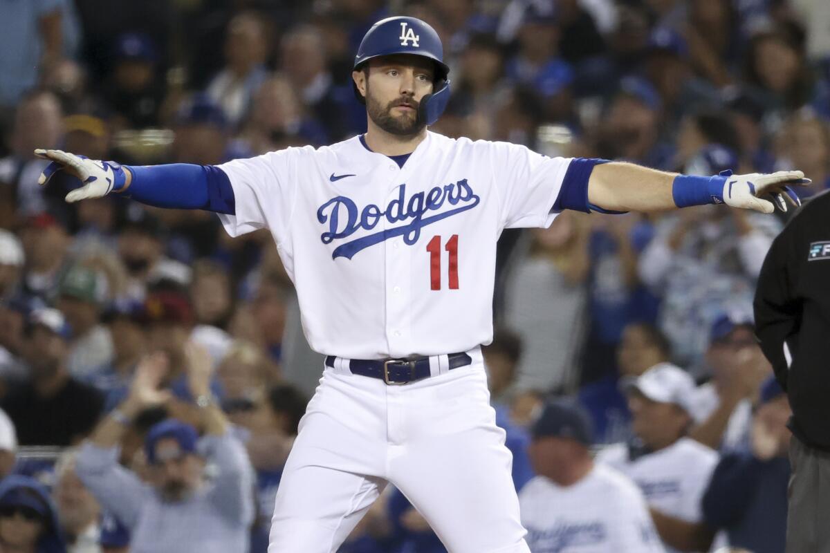 Dodgers' AJ Pollock celebrates after hitting a single.