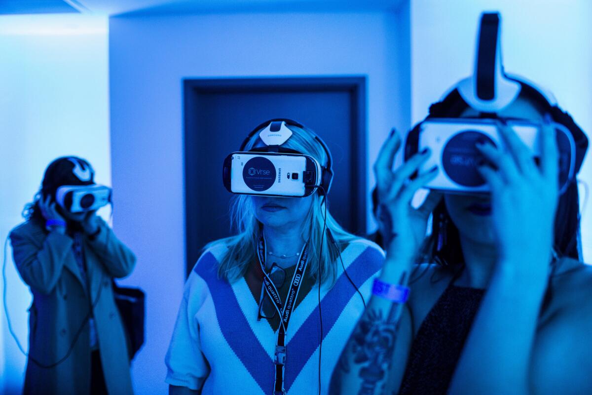 People watch virtual reality content produced by Vrse.Works, during a filmmaker welcome party, with a preview of virtual reality technologies at the AFI Fest 2015.