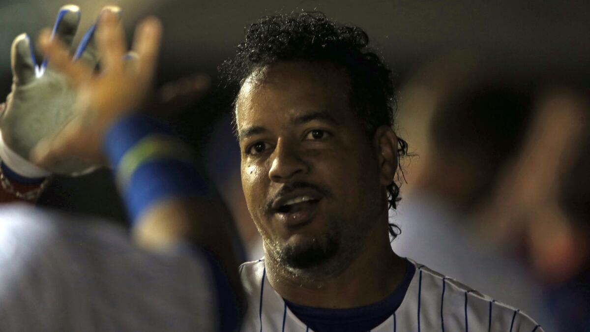 Former Dodgers outfielder Manny Ramirez is congratulated by one of his Iowa Cubs teammates during a game in Des Moines, Iowa, on June 30. Ramirez has struggled during his time with the Cubs.