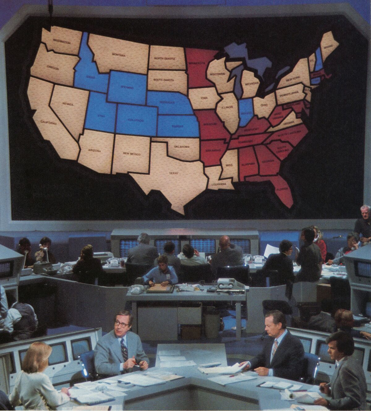 The original NBC electoral map, first seen on Nov. 2, 1976. Pictured, from left, Cassie Mackin, John Chancellor, David Brinkley, and Tom Brokaw. (Indiana Historical Society / NBC)