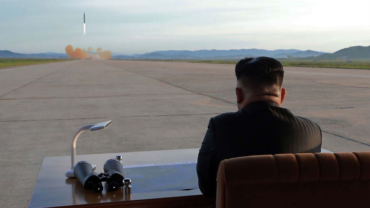 North Korean leader Kim Jong-un watches a missile launch.