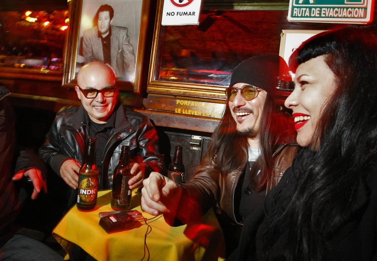 Ramon Amezcua (Bostich), left, and Pepe Mogt (Fussible), co-founders of the pioneering group Nortec Collective, share drinks with friends at Tijuana's Dandy del Sur. "In 2007 we were afraid to go in the night to the bars, to live the night-life style of Tijuana," said Bostich. "But here, starting with Sixth Avenue, the people started to take back the streets."