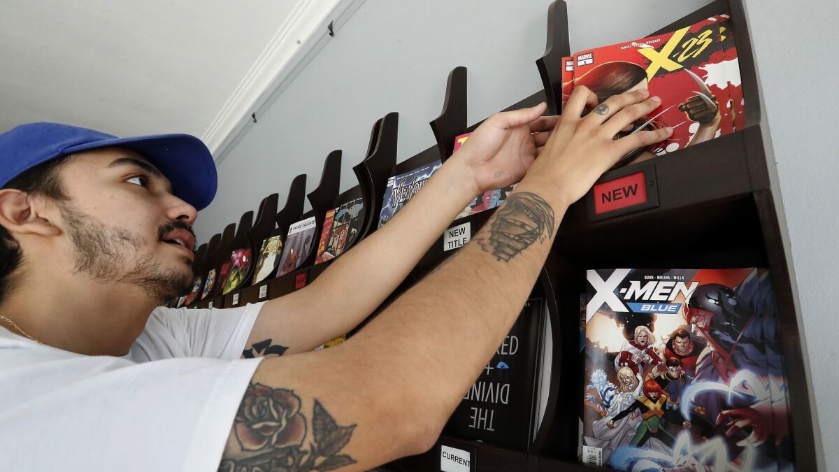 Gordon Medina, 24, of Los Angeles looks at the Marvel comic book, X-23, for sale at Secret Headquarters on Sunset Blvd. in Los Angeles on July 11, 2018.