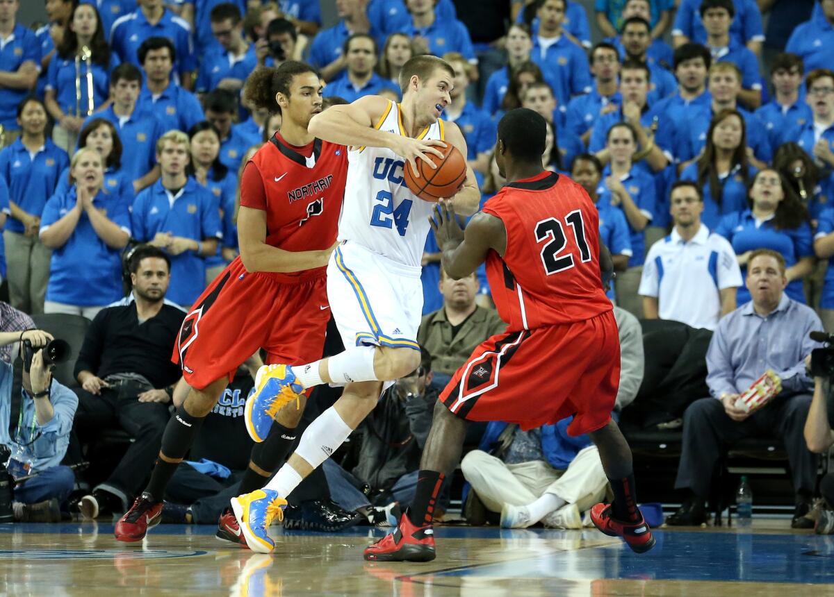 UCLA forward Travis Wear drives against Cal State Northridge's Tre Hale-Edmerson and Stephen Maxwell (21) at Pauley Pavilion.