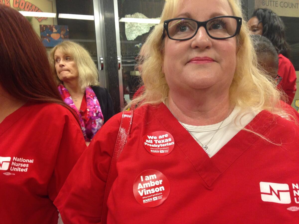 Sandy Reding, an operating room nurse at Bakersfield Memorial Hospital in Bakersfield, attended a meeting on Ebola preparedness with Gov. Jerry Brown on Tuesday. Her stickers show solidarity with the two nurses who contracted the disease while treating an Ebola-infected patient at Texas Health Presbyterian Hospital.