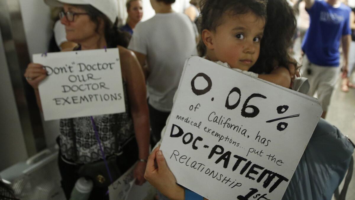 Parents who oppose a bill in the California Legislature to give more authority to state public health officials in deciding on vaccination exemptions wait to get into a committee hearing in Sacramento on April 24.