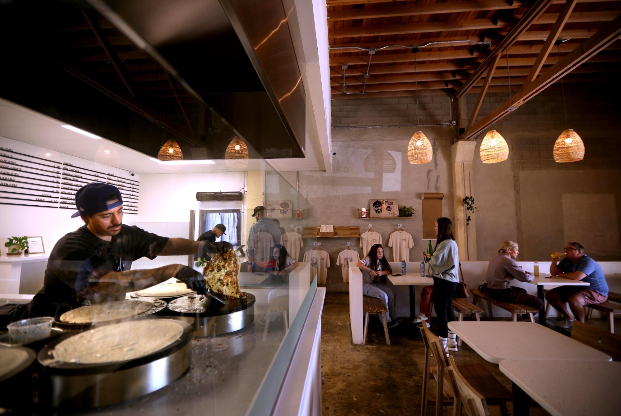 Marcel Ramirez, owner of Gabino's Creperie East, makes crepes for customers in Indio.