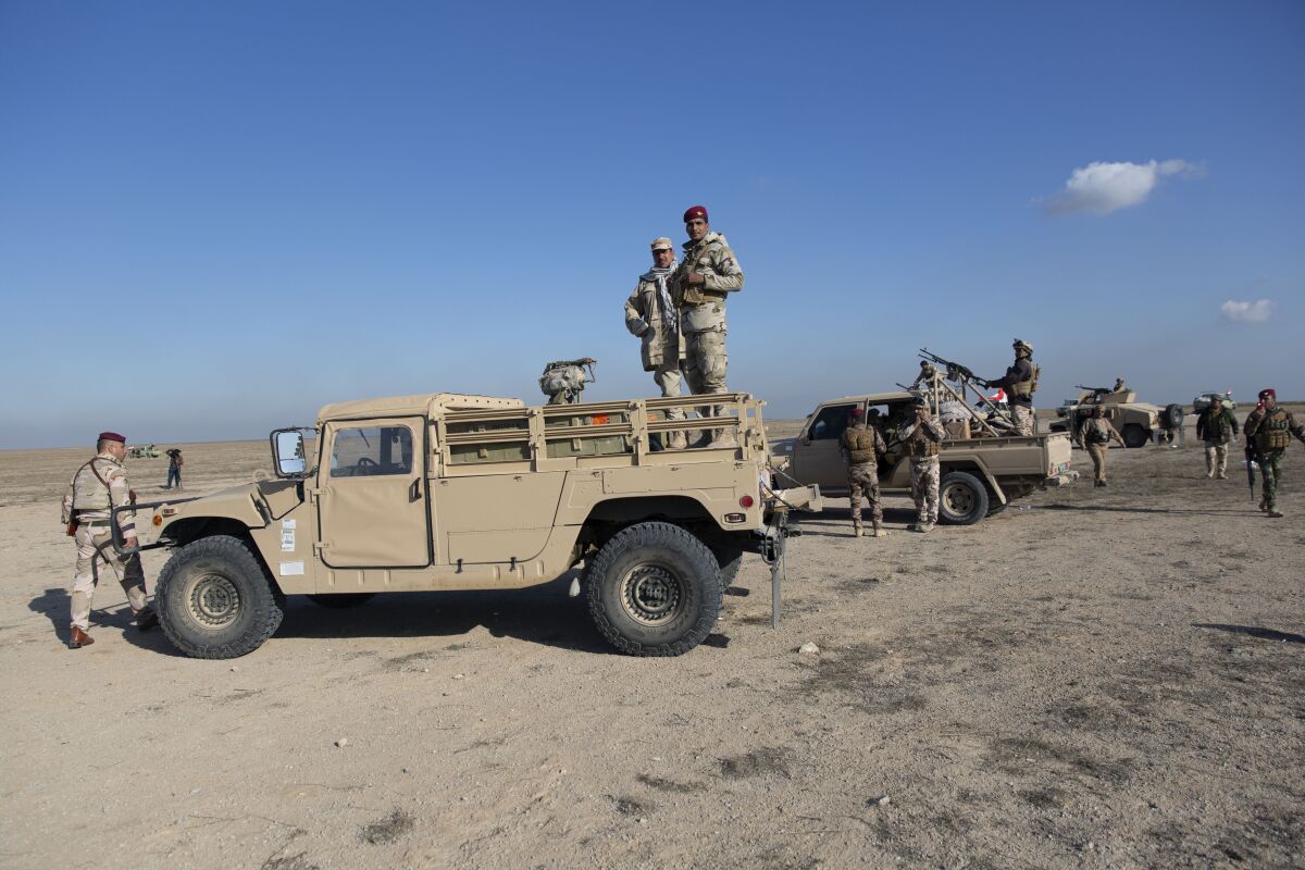 Iraqi army units provide security Sunday at an Anbar air base that hosts U.S. forces after a series of attacks on U.S.-led coalition forces.
