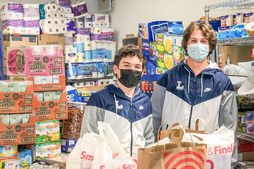 Loyola lacrosse players Henry Kupiece (left) and Hudson O'Hanlon started Groceries for Good during the pandemic to shop for others with no charge.
