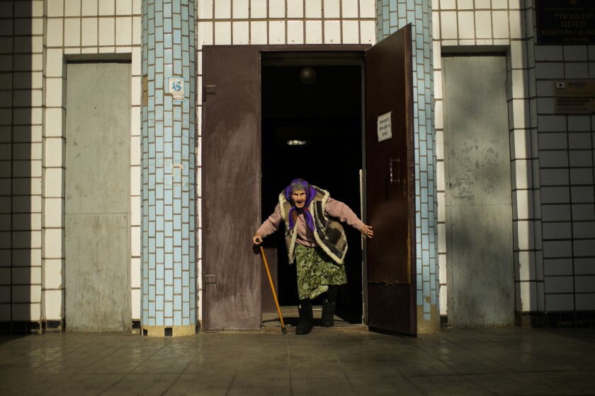 Woman bursting through doors of building
